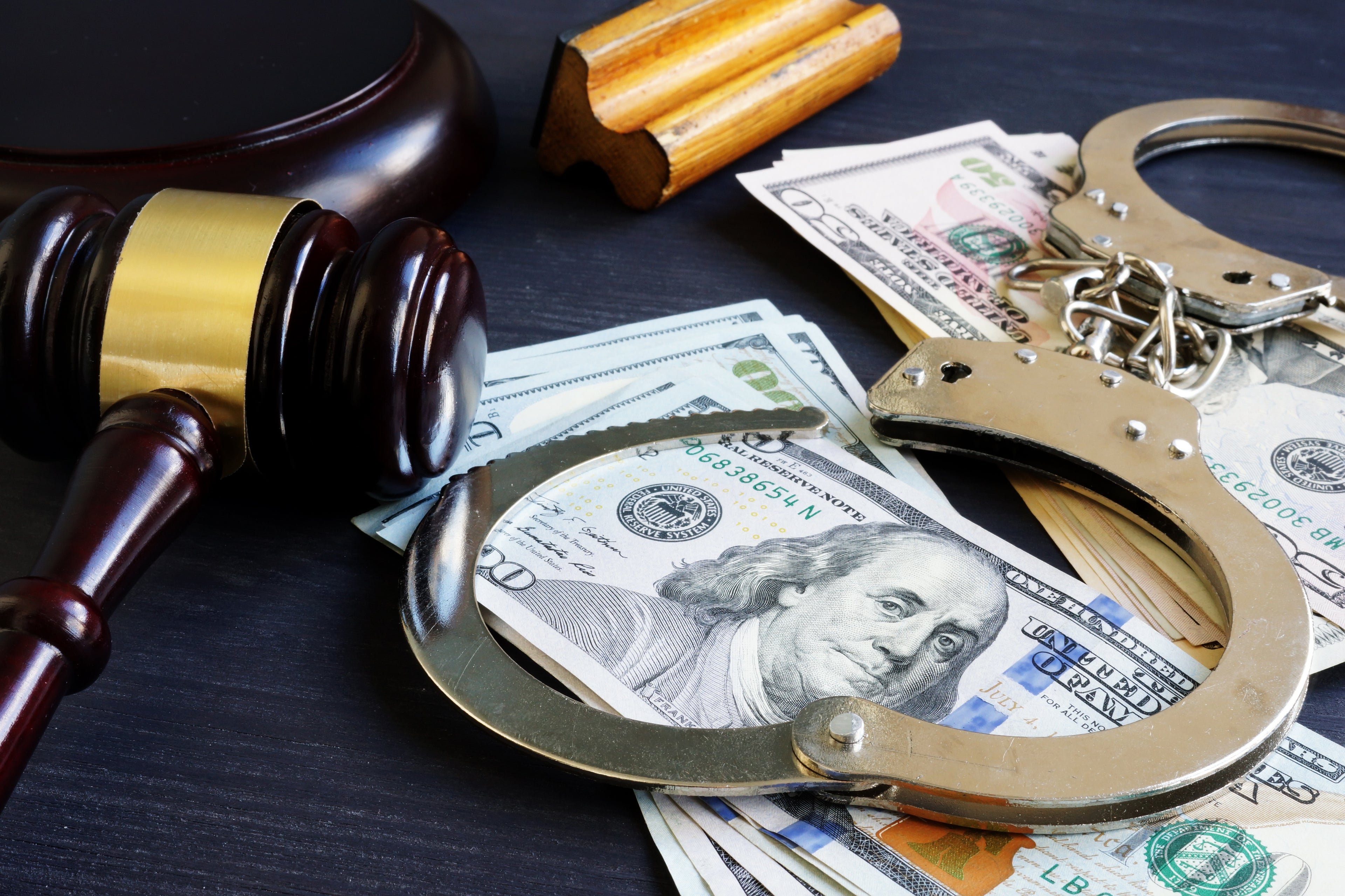 Money, handcuffs, judge gavel